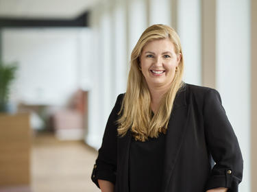 Gina Helmond standing in an office